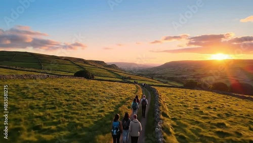 Hikers walk along a scenic trail at sunset during UK National Walking Month.