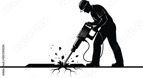 Silhouette of a construction worker operating a jackhammer on pavement