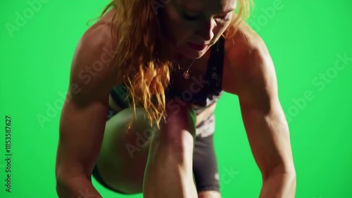 Athlete tying bright neon footwear laces on green screen background