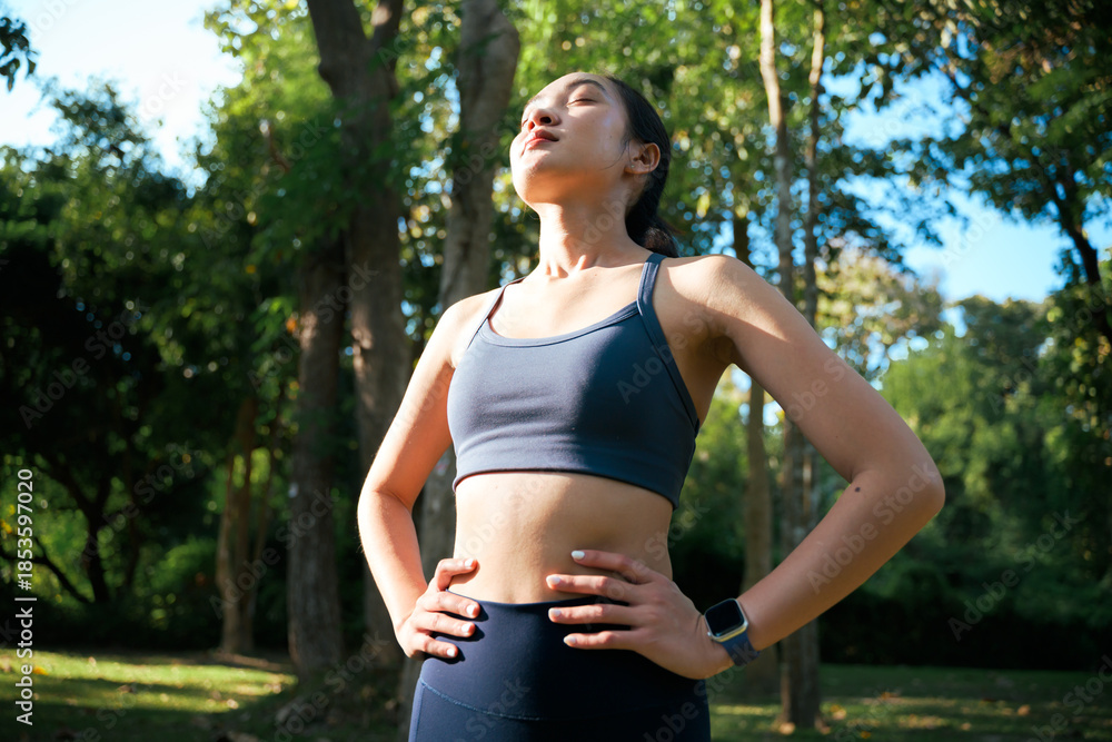 Fototapeta premium Young woman enjoying fresh air in park