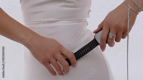 In the hands of a woman close-up modern apple smart watch