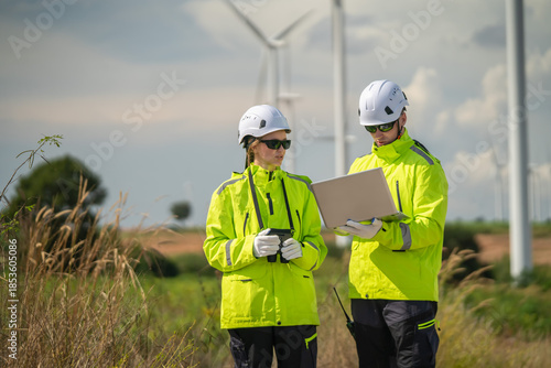 Team collaboration on renewable energy project wind farm professional consultation outdoor close-up innovation