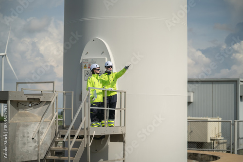 Slika na platnu Safety briefing for wind turbine workers industrial site training session outdoo