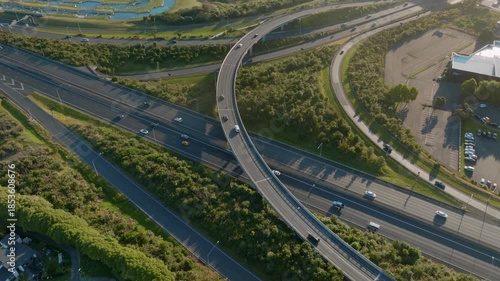 Aerial view of cars driving on a highway interchange in Manukau, Auckland, New Zealand. The scene shows the infrastructure and transportation system.