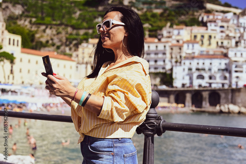  Happy smiling beautiful  Tourist woman   traveling in Italy poses and making photos  Vacation on  Positano and Amalfi coast in Italy.  Italy trip 