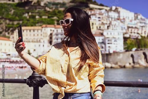  Happy smiling beautiful  Tourist woman   traveling in Italy poses and making photos  Vacation on  Positano and Amalfi coast in Italy.  Italy trip 