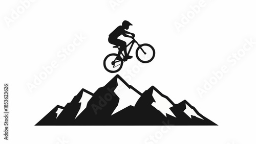 Silhouette of a mountain biker jumping over rocky peaks.