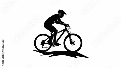 Silhouette of a mountain biker riding a bicycle.