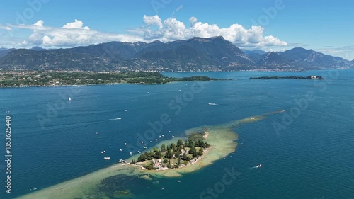 Cinematic 4K drone video of Isola di San Biagio, Lake Garda, Italy, showing peaceful island and landscape.