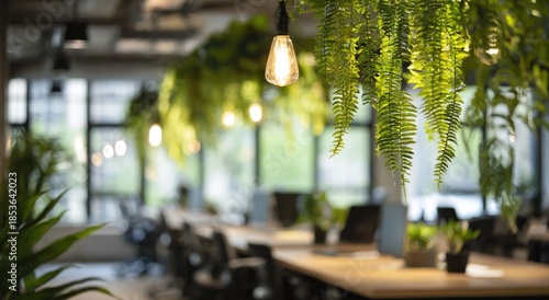 Lush greenery drapes from ceiling above modern, sunlit office workstations