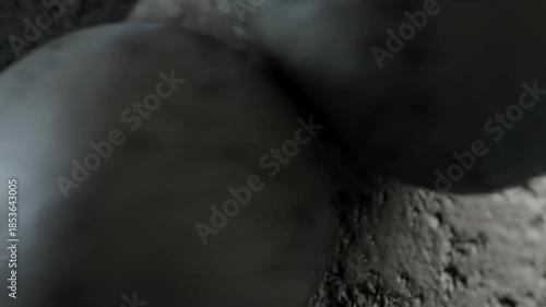 Dark textured stones tumbling in slow motion.
