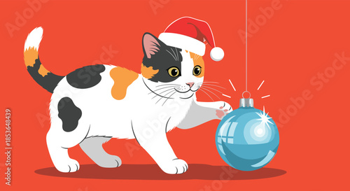 Playful calico kitten with a festive Santa hat on its head curiously touching a shiny blue Christmas tree ornament.