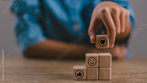 Social media engagement, Digital marketing concept. Stacking the wooden cube blocks with emoticons, creating social media platforms to build relationships and drive sales. Sharing customer experience.