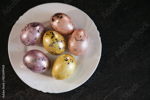 Wallpaper Mural Painted eggs lie on a white plate, top view, preparation for the Easter holiday Torontodigital.ca
