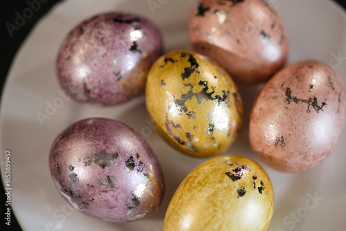 Wallpaper Mural Painted eggs lie on a white plate, top view, preparation for the Easter holiday Torontodigital.ca