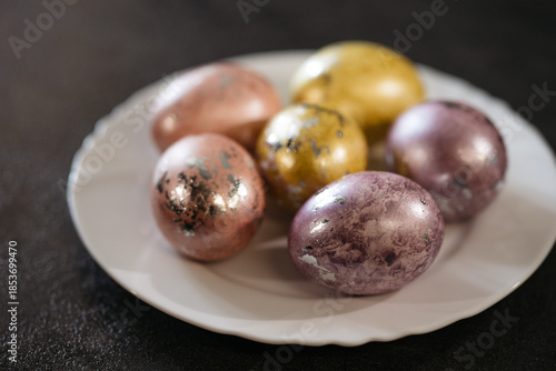 Wallpaper Mural Painted eggs lie on a white plate, top view, preparation for the Easter holiday Torontodigital.ca