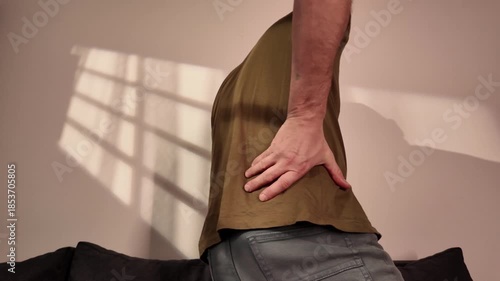 Wallpaper Mural Man with hip, back, spine and sciatica pain at home. Torontodigital.ca