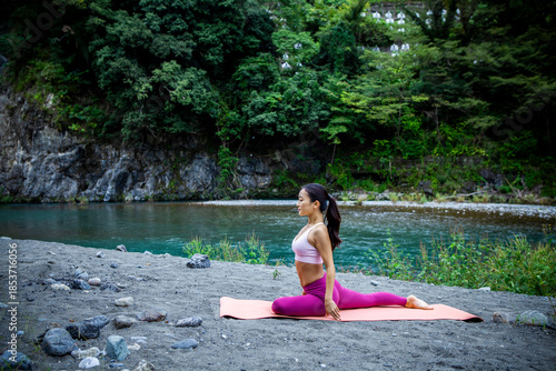 Woman Stretching Hips in Low Lunge Yoga Pose on Riverside Yoga Mat