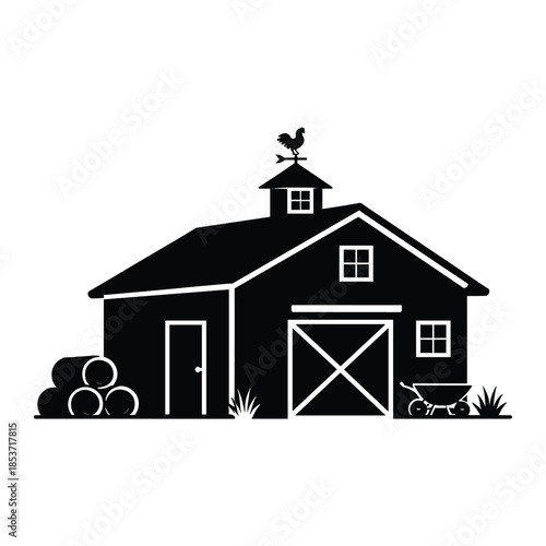 Black silhouette of farm barn with hay and wheelbarrow