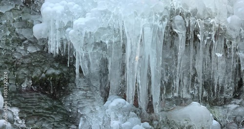 Wallpaper Mural Majestic ice formations create a stunning winter display, showcasing nature's artistic prowess. Translucent icicles cascade down a rugged surface, shimmering under the cold light. Torontodigital.ca