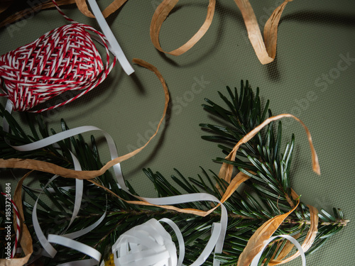 Christma wrapping ribbon and string green background