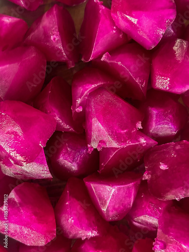 Pile of frozen purple beetroot ice cubes texture background