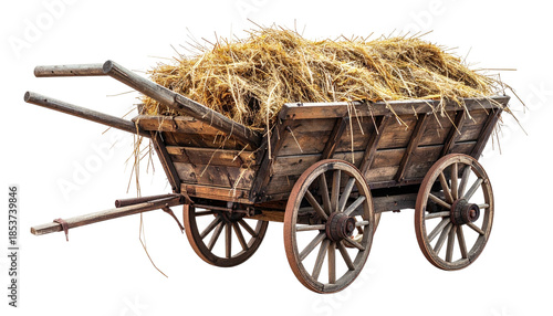 Old wooden cart overflowing with golden hay, isolated on black