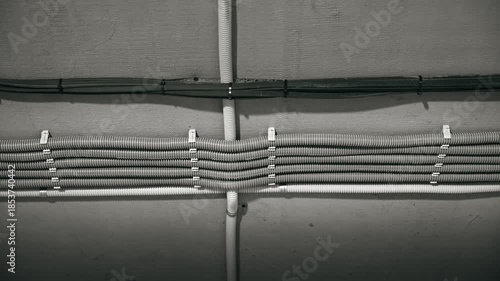 Organized Wiring Setup, Methodical Conduit Placement With Secure Fasteners And Neat Arrangement