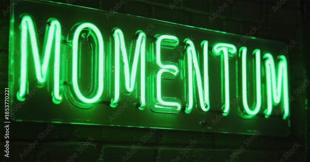 Fototapeta premium Bright green neon sign spells MOMENTUM against dark brick wall. Bold lettering creates striking visual impact. Simple, modern aesthetic.