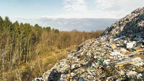 The landscape is covered in a thick layer of trash, the smell and view are terrible, the mountain of trash behind is a landfill for a large city in Eastern Europe.