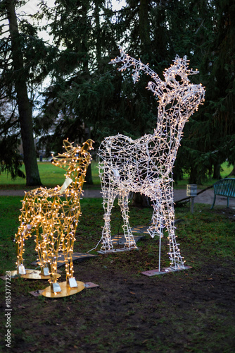 Photo of New Year street lanterns decorated with festive lights on a winter street at night. Warm illumination and holiday decorations create a cozy seasonal atmosphere, ideal for Christmas and New