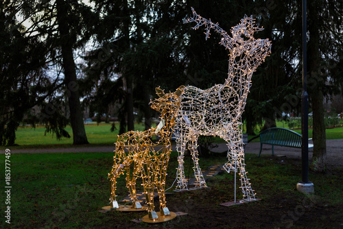 Photo of New Year street lanterns decorated with festive lights on a winter street at night. Warm illumination and holiday decorations create a cozy seasonal atmosphere, ideal for Christmas and New