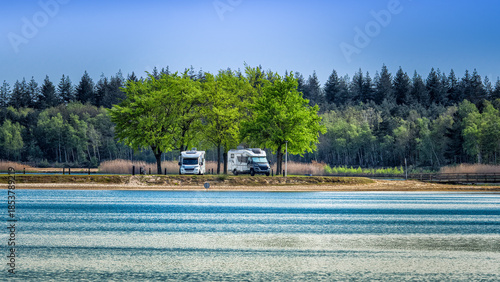 Camper vans parked near lake in Eersel, Netherlands