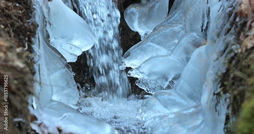 Wallpaper Mural Frozen waterfall: captured the enchanting sight of a small waterfall cascading amidst icy formations, a mesmerizing dance of nature's elements. Torontodigital.ca