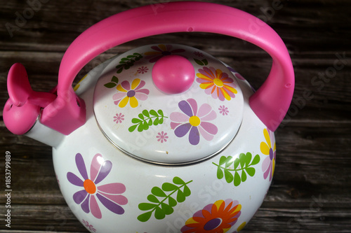 An enamel stovetop kettle, a metal kettle (often steel) coated in a smooth, glassy enamel finish, known for being beautiful, heating water quickly and evenly, and providing clean tasting water