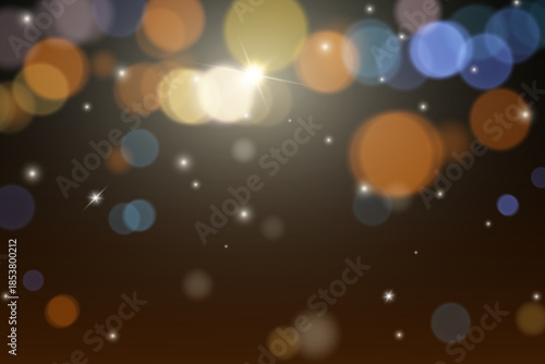 Abstract colorful bokeh lights background with glowing particles.