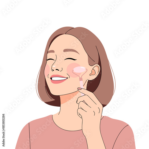 Young woman smiling while using facial massage tool at home  