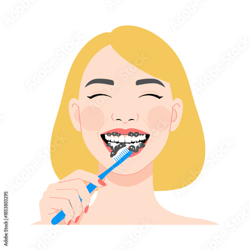 Young woman smiling while brushing teeth with activated charcoal toothpaste  