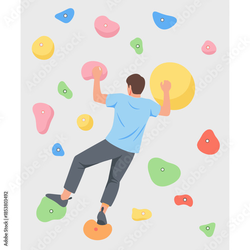 Man climbing on colorful bouldering wall in indoor gym  