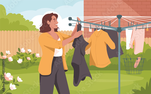 Woman hanging clothes on a drying rack in a sunny backyard garden with flowers and a wooden fence