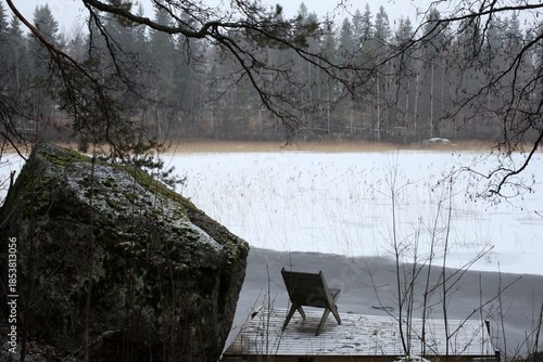 Winter landscape on a lake with chair