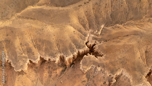 Rugged desert terrain with deep canyons and layered rock formations