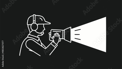 Film director with spotlight and headphones on black background.