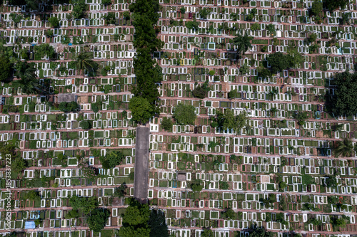 Aerial view of countless graves and headstones stand in stark uniformity against patches of green, creating a somber landscape at Azimpur Graveyard, Dhaka, Dhaka Division, Bangladesh.