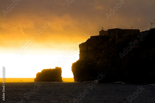 lighthouse of Nazaré, Portugal, at sunset.
