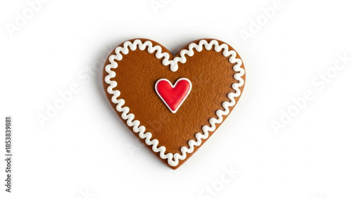 Heart shaped gingerbread cookie with white icing and red heart decoration on white background for valentines day or christmas