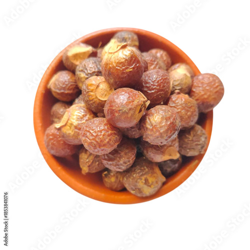 soapnuts on clay small bowl isolated on white background - 1