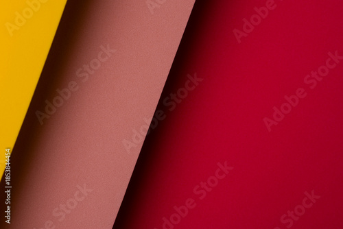 Bright colors create a pattern with yellow, brown, and red paper layered together in a modern design
