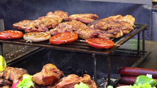 Wallpaper Mural Sizzling sausages and succulent meat cook to perfection on a metal grill, smoke rising, promising a feast. Mouthwatering and appetizing barbeque grilling outdoor. Torontodigital.ca