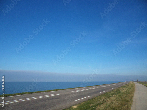 Road and Blue sky with sea. Minimalist view. Nature backdrop. Beautiful natural flyer, card design. Nature Template for presentation or product 